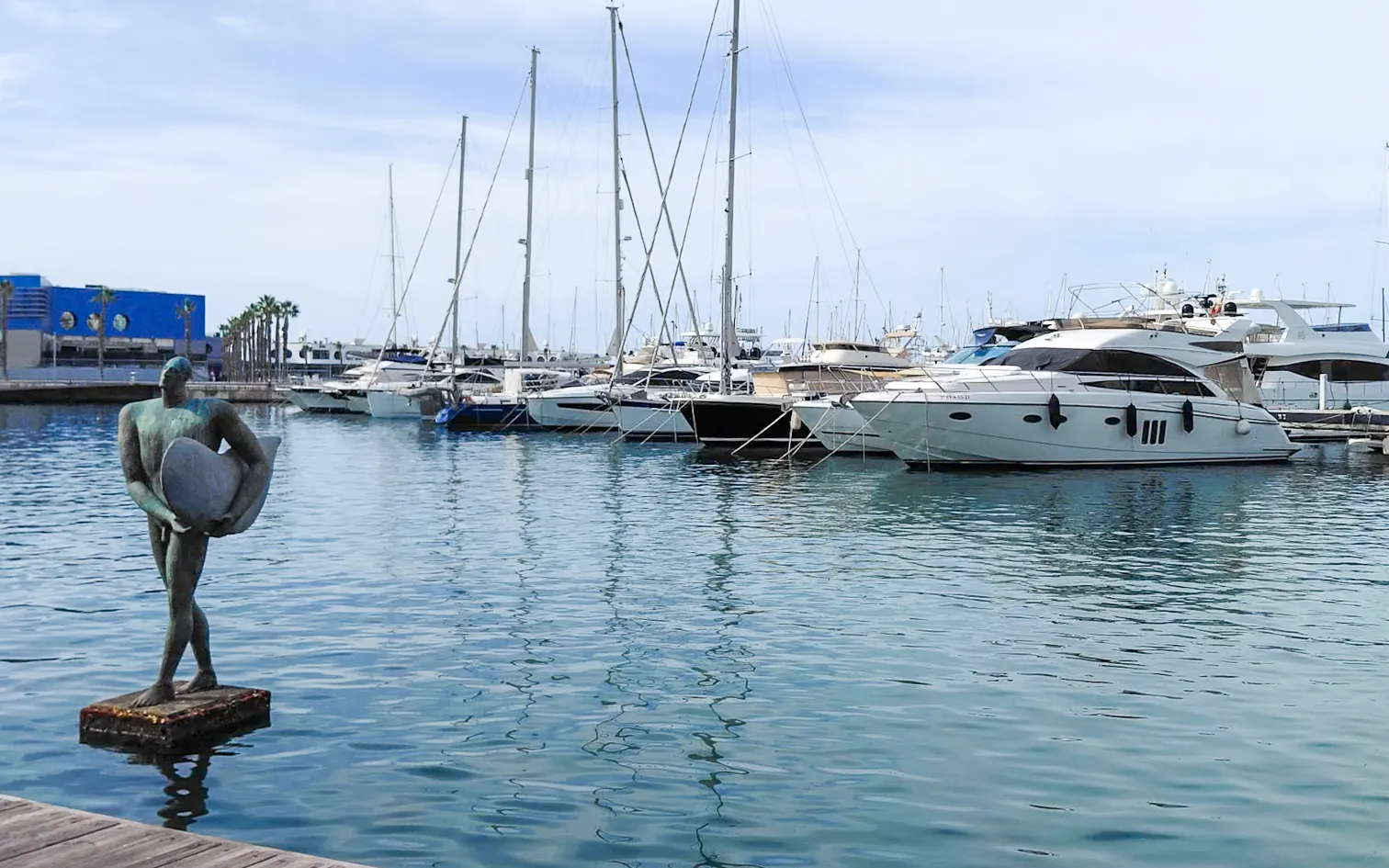 Harbor statue overlooking moored sailboats and calm waters | Foto Walk 2026 Alicante | MarkOWiHu Photographer