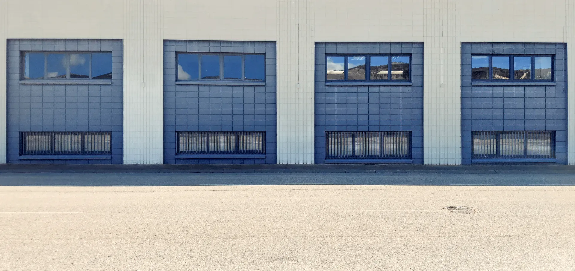 Four blue industrial windows on smooth grey facade | Found Minimalism | Alicante province | MarkOWiHu Photographer Fotógrafo • markowihu.es