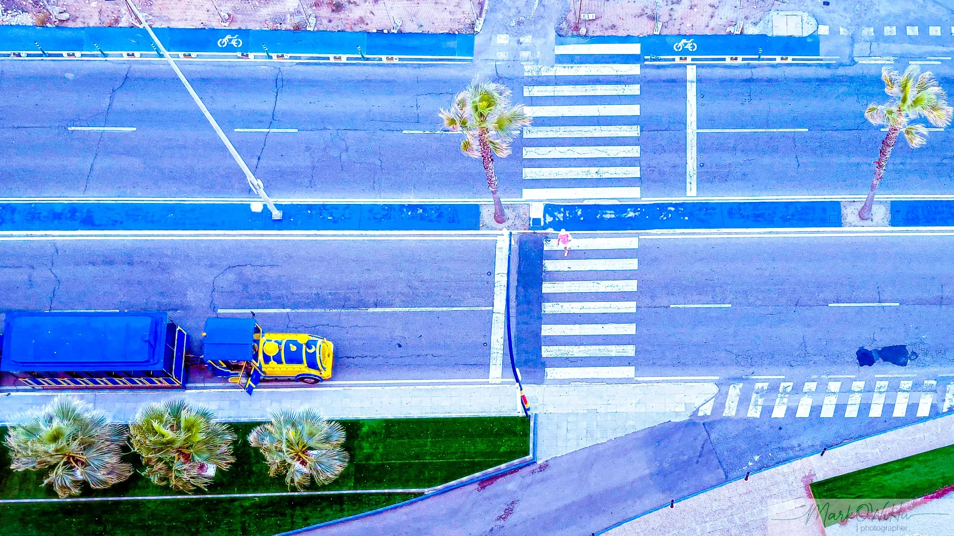Top-down aerial street perspective showing road train and blue bike lane zebra crossing | Street & Humanity | Alicante province | MarkOWiHu Photographer Fotógrafo • markowihu.es